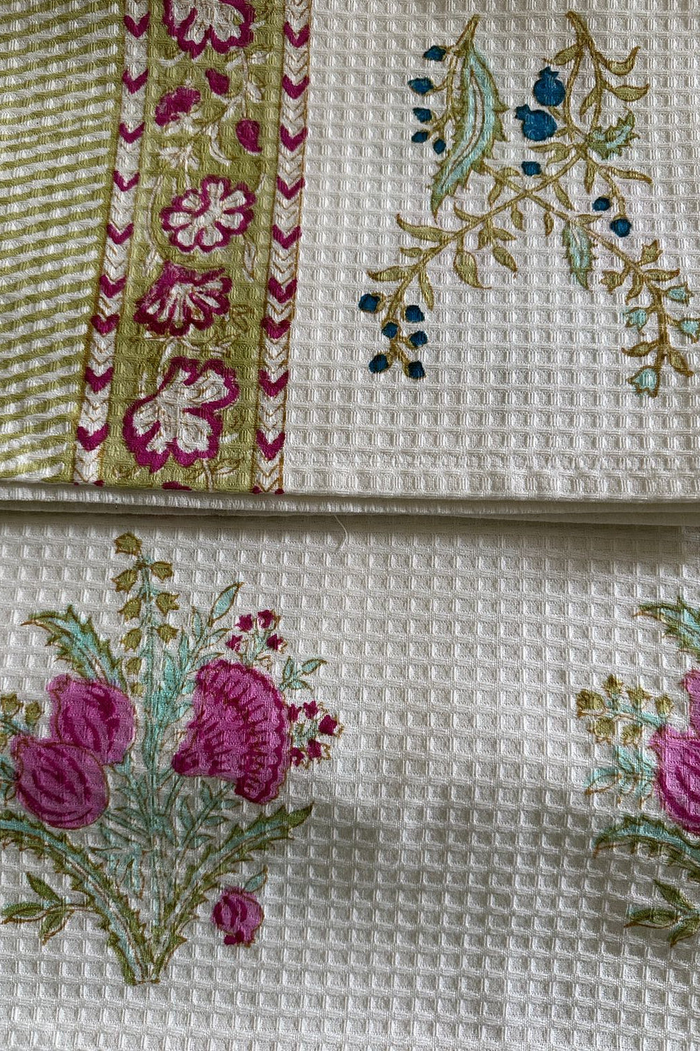 Embroidered fabric with floral patterns on a textured white background