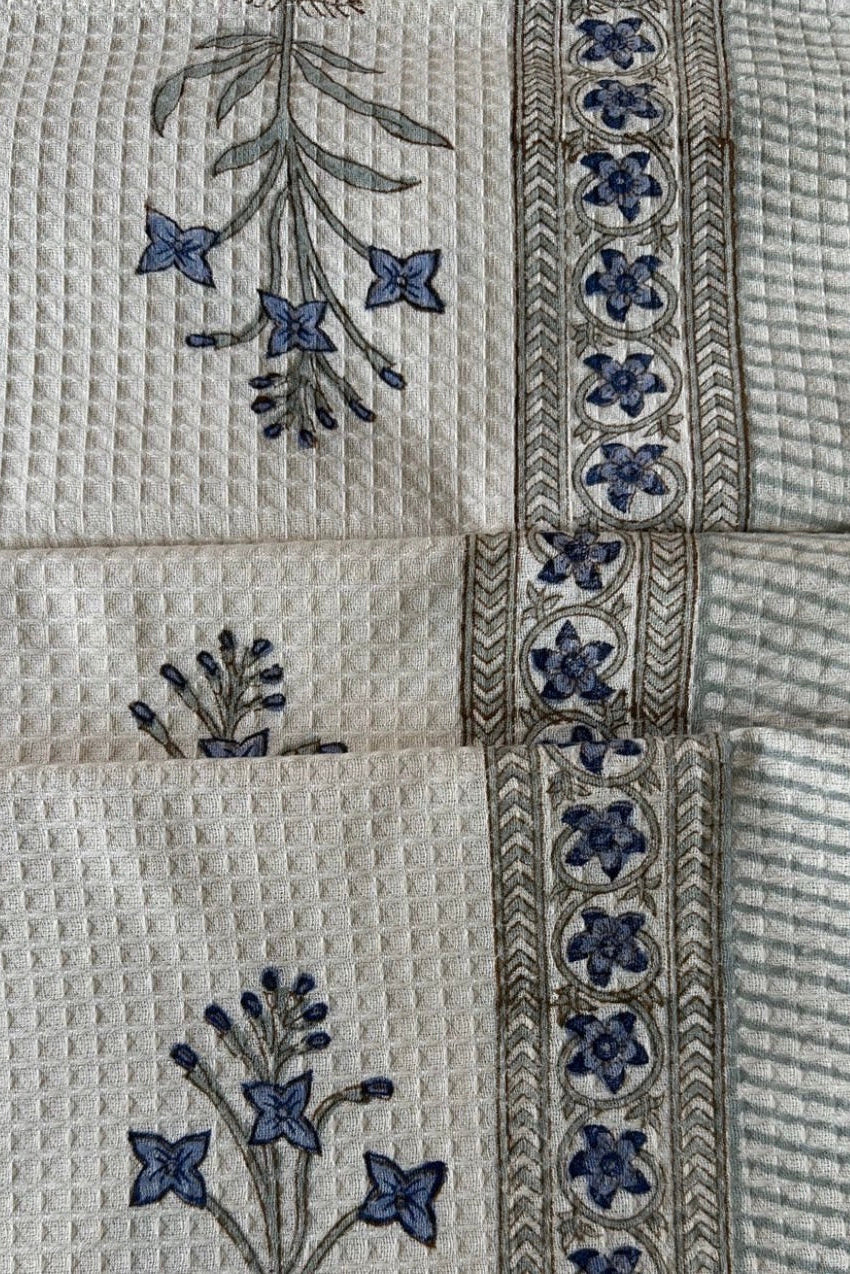 Textile with floral embroidery and textured patterns
