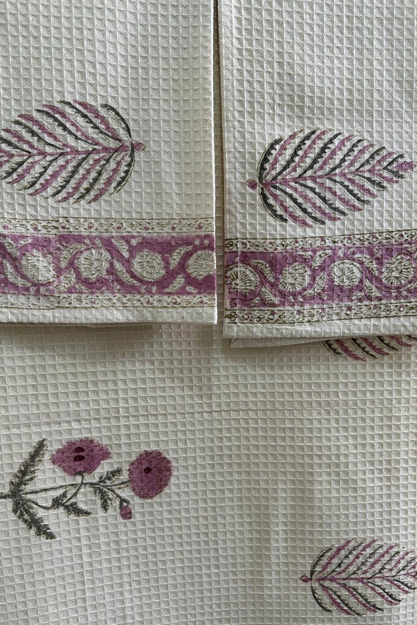 Decorative fabric with floral and leaf patterns on a white background