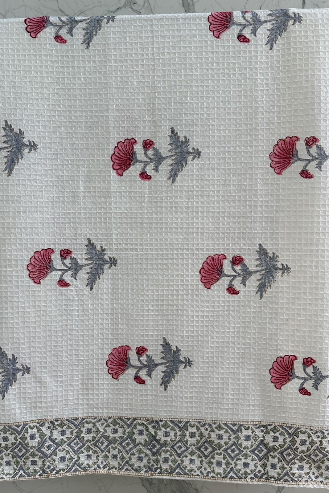 Floral patterned fabric with red and gray flowers on a white background