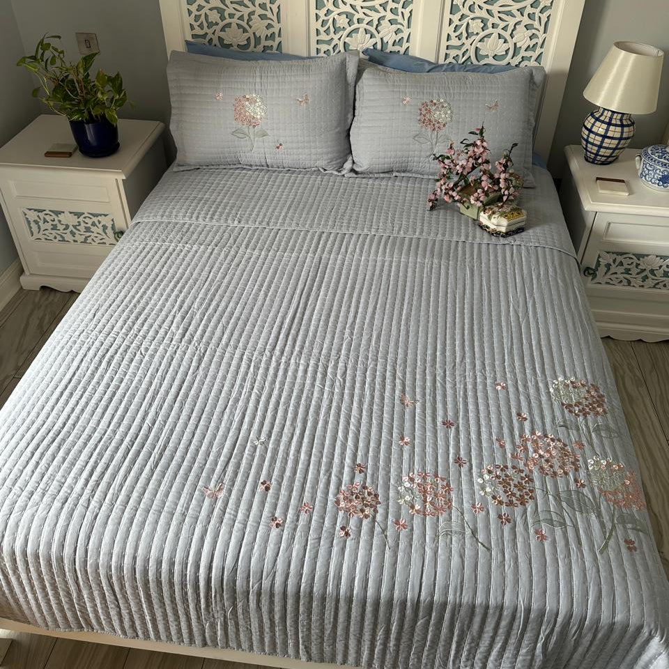 Bedroom with a bed featuring a decorative headboard and floral patterns on bedding.