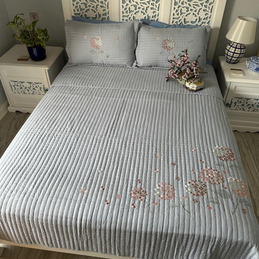 Bedroom with a bed featuring a decorative headboard and floral patterns on bedding.