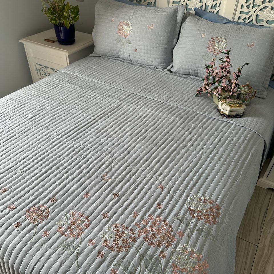 Bed with floral-patterned bedding in a bedroom setting