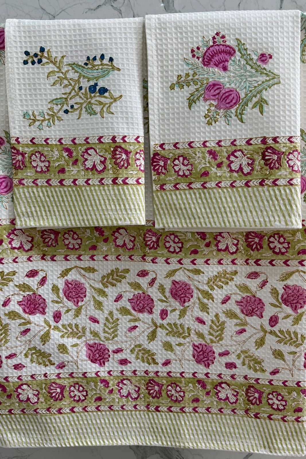 Set of floral patterned towels on a marble surface