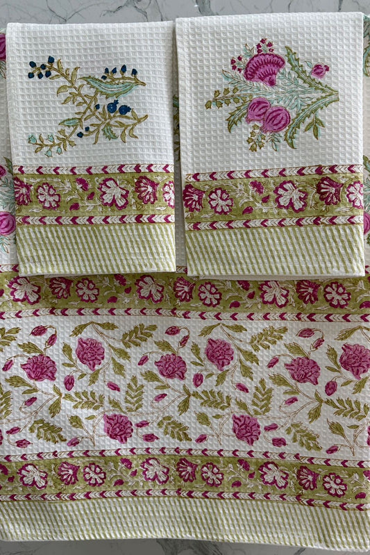 Set of floral patterned towels on a marble surface