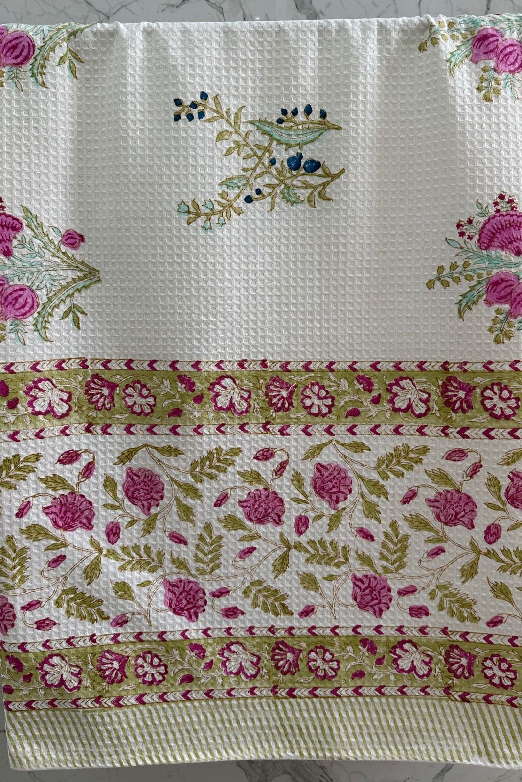 Decorative towel with floral patterns on a textured surface